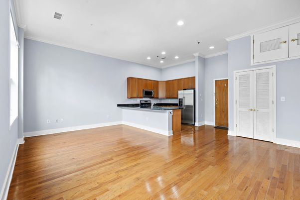 Empty room, Interior, Kitchen, Recessed Lighting, Stainless Steel Appliances, Wood Texture Flooring