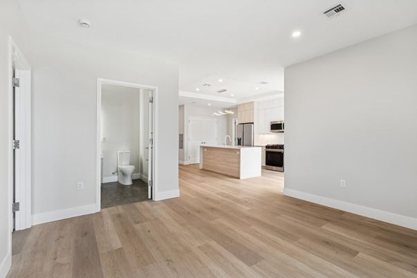 Empty room, Interior, Kitchen, Recessed Lighting, Stainless Steel Appliances, Wood Texture Flooring