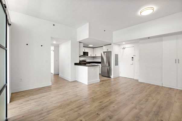 Empty room, Interior, Kitchen, Recessed Lighting, Stainless Steel Appliances, Wood Texture Flooring