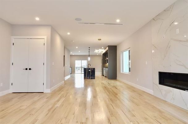 Empty room, Fireplace, Interior, Marble Walls, Pendant Lights, Recessed Lighting, Wood Texture Flooring