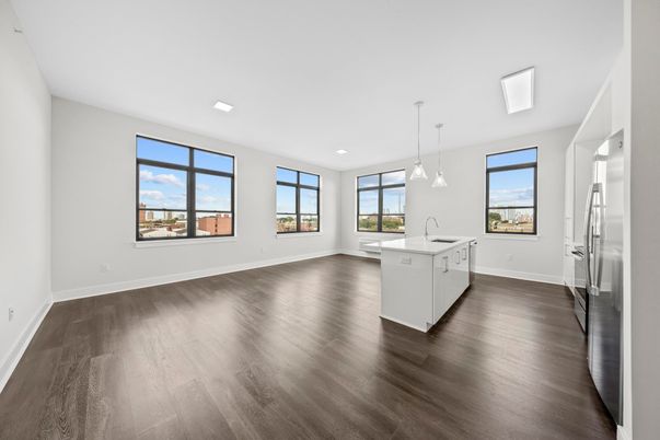Empty room, Interior, Kitchen, Pendant Lights, Recessed Lighting, Stainless Steel Appliances, Wood Texture Flooring