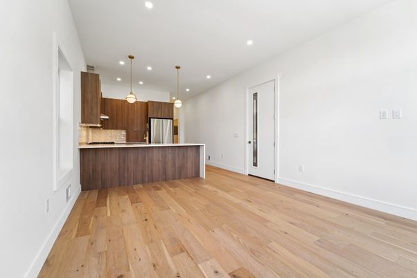 Empty room, Interior, Kitchen, Pendant Lights, Recessed Lighting, Stainless Steel Appliances, Wood Texture Flooring