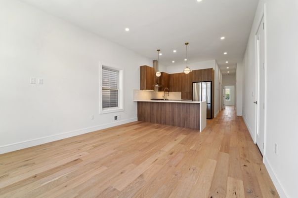 Empty room, Interior, Kitchen, Pendant Lights, Recessed Lighting, Stainless Steel Appliances, Wood Texture Flooring