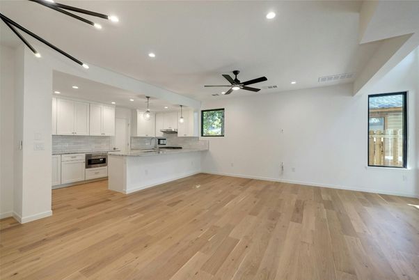 Empty room, Interior, Kitchen, Pendant Lights, Recessed Lighting, Stainless Steel Appliances, Wood Texture Flooring