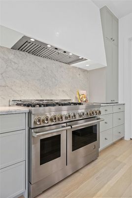 Interior, Kitchen, Marble Walls, Recessed Lighting, Stainless Steel Appliances, Wood Texture Flooring