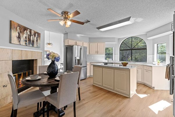 Dining room, Fireplace, Interior, Kitchen, Pendant Lights, Stainless Steel Appliances, Wood Texture Flooring