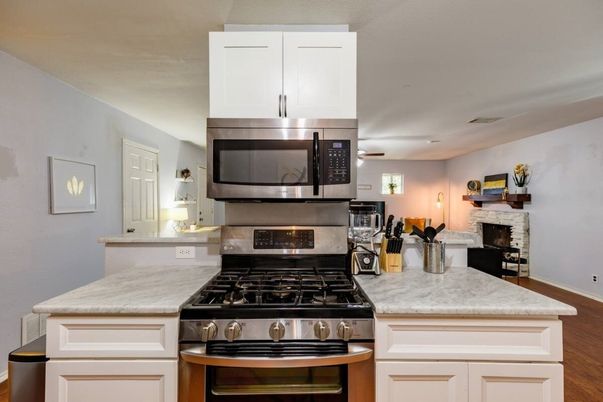 Fireplace, Interior, Kitchen, Stainless Steel Appliances, Wood Texture Flooring