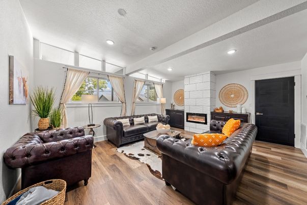 Fireplace, Interior, Living room, Recessed Lighting, Stone Walls, Wood Texture Flooring