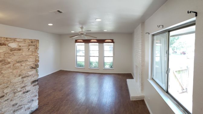 Empty room, Fireplace, Interior, Recessed Lighting, Stone Walls, Wood Texture Flooring