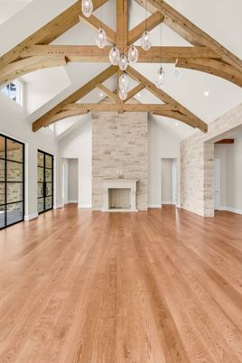 Empty room, Fireplace, Interior, Pendant Lights, Recessed Lighting, Stone Walls, Wooden Beams, Wood Texture Flooring