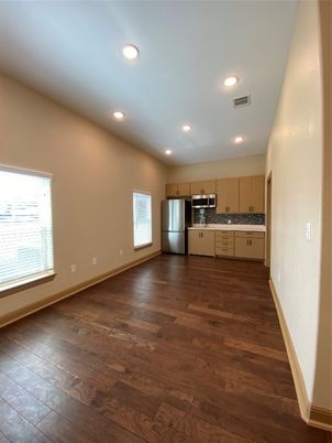 Empty room, Interior, Kitchen, Recessed Lighting, Stainless Steel Appliances, Wood Texture Flooring