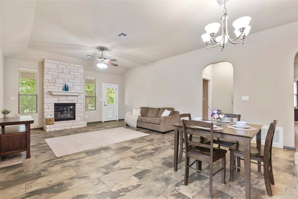 Chandelier, Dining room, Fireplace, Interior, Living room, Stone Walls, Wood Texture Flooring