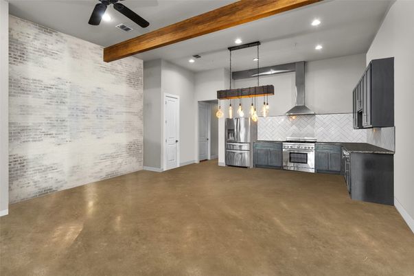 Empty room, Interior, Kitchen, Pendant Lights, Recessed Lighting, Stainless Steel Appliances, Stone Walls, Wooden Beams
