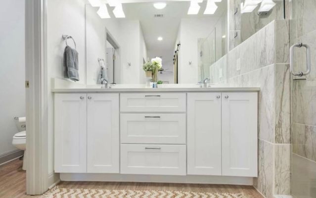 Bathroom, Dual Sink Vanities, Glass Shower, Interior, Marble Walls, Recessed Lighting, Wood Texture Flooring