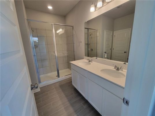 Bathroom, Dual Sink Vanities, Glass Shower, Interior, Recessed Lighting, Wood Texture Flooring