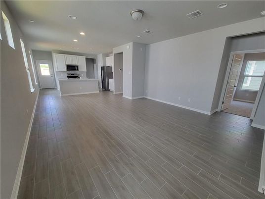 Empty room, Interior, Kitchen, Recessed Lighting, Stainless Steel Appliances, Wood Texture Flooring