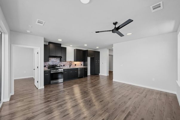 Empty room, Interior, Kitchen, Recessed Lighting, Stainless Steel Appliances, Wood Texture Flooring