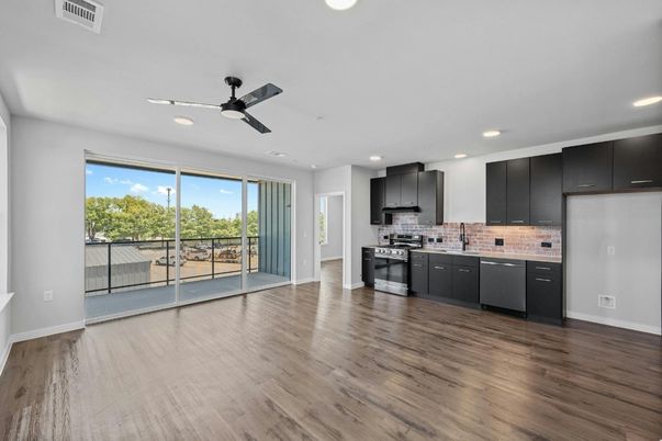 Empty room, Interior, Kitchen, Recessed Lighting, Stainless Steel Appliances, Wood Texture Flooring