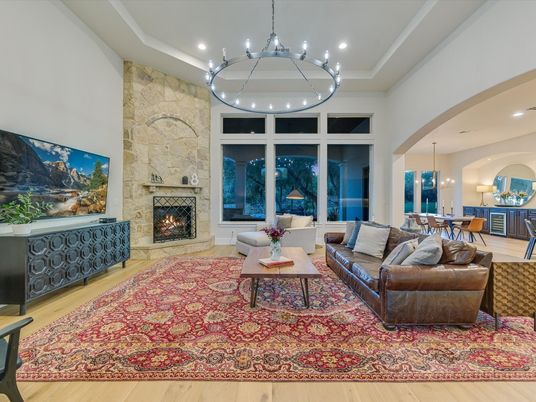 Chandelier, Dining room, Fireplace, Interior, Living room, Pendant Lights, Recessed Lighting, Stone Walls, Wood Texture Flooring