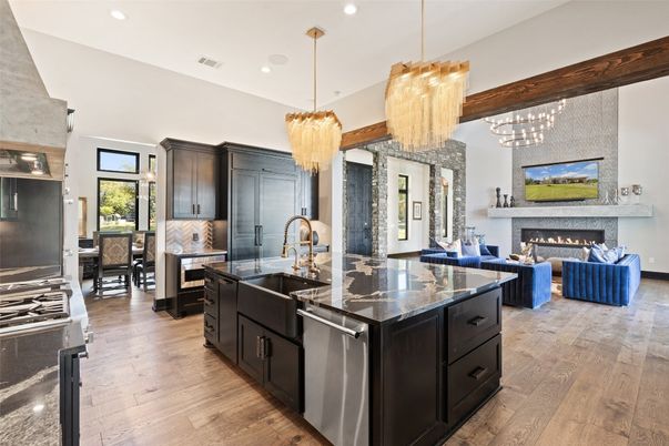 Chandelier, Dining room, Fireplace, Interior, Kitchen, Living room, Pendant Lights, Recessed Lighting, Stainless Steel Appliances, Wood Texture Flooring