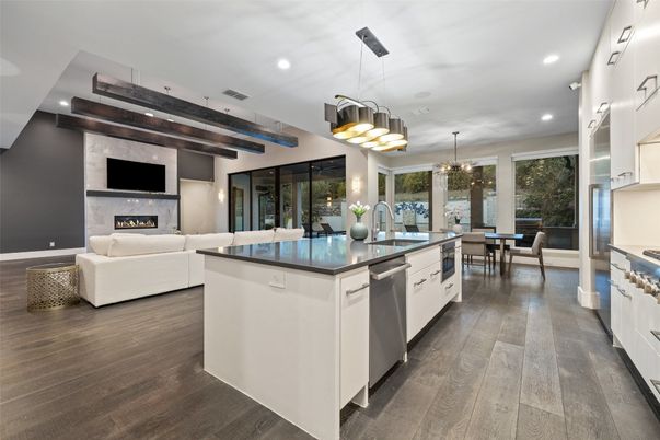 Chandelier, Dining room, Fireplace, Interior, Kitchen, Living room, Pendant Lights, Recessed Lighting, Stainless Steel Appliances, Wood Texture Flooring