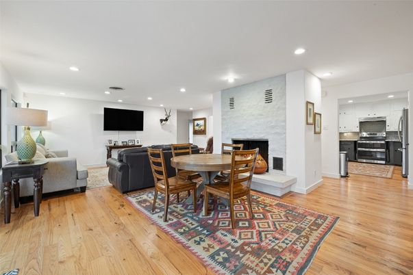 Dining room, Fireplace, Interior, Kitchen, Living room, Recessed Lighting, Stainless Steel Appliances, Wood Texture Flooring