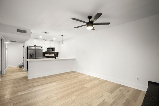 Empty room, Interior, Kitchen, Pendant Lights, Recessed Lighting, Stainless Steel Appliances, Wood Texture Flooring