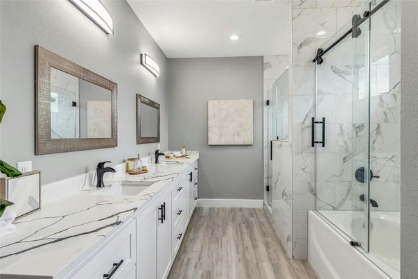Bathroom, Dual Sink Vanities, Glass Shower, Interior, Marble Walls, Recessed Lighting, Wood Texture Flooring