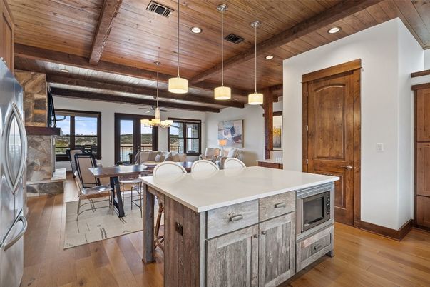 Chandelier, Dining room, Interior, Kitchen, Pendant Lights, Recessed Lighting, Stainless Steel Appliances, Wooden Beams, Wooden Ceilings, Wood Texture Flooring