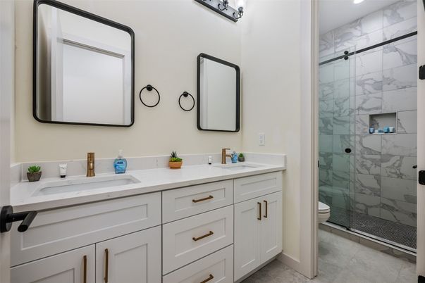 Bathroom, Dual Sink Vanities, Glass Shower, Interior, Marble Walls, Recessed Lighting