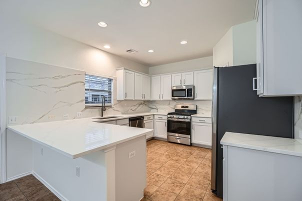 Interior, Kitchen, Marble Walls, Recessed Lighting, Stainless Steel Appliances