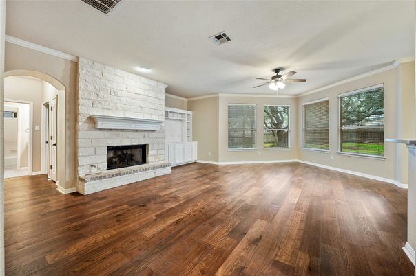 Empty room, Fireplace, Interior, Recessed Lighting, Stone Walls, Wood Texture Flooring