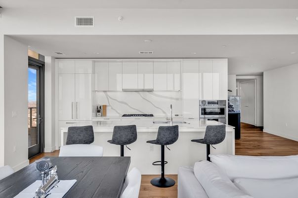 Interior, Kitchen, Marble Walls, Recessed Lighting, Stainless Steel Appliances, Wood Texture Flooring