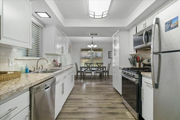Chandelier, Dining room, Interior, Kitchen, Stainless Steel Appliances, Wood Texture Flooring