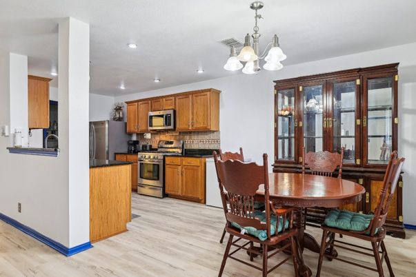 Chandelier, Dining room, Interior, Kitchen, Recessed Lighting, Stainless Steel Appliances, Wood Texture Flooring