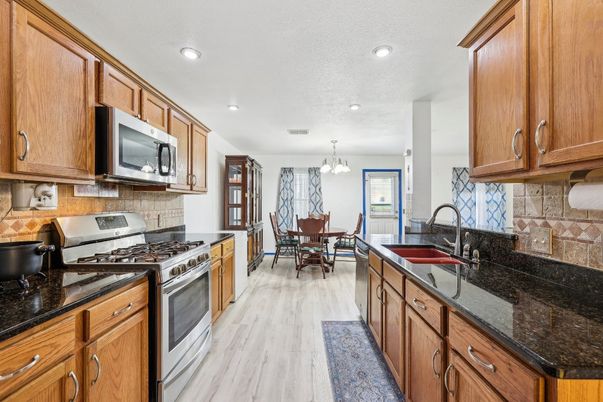 Chandelier, Dining room, Interior, Kitchen, Recessed Lighting, Stainless Steel Appliances, Wood Texture Flooring