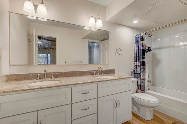 Bathroom, Dual Sink Vanities, Glass Shower, Interior, Recessed Lighting, Wood Texture Flooring