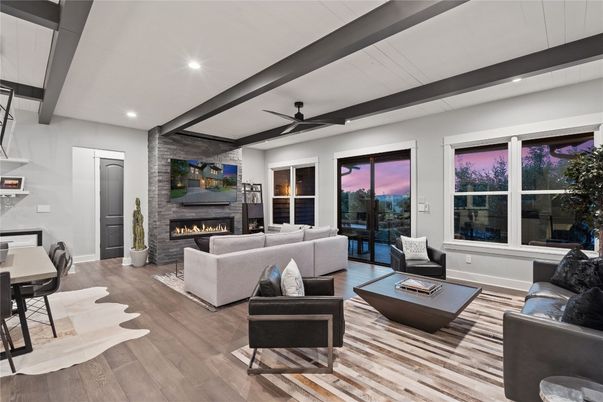 Dining room, Fireplace, Interior, Living room, Recessed Lighting, Stone Walls, Wood Texture Flooring