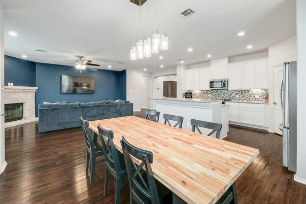 Dining room, Fireplace, Interior, Kitchen, Living room, Pendant Lights, Recessed Lighting, Stainless Steel Appliances, Wood Texture Flooring