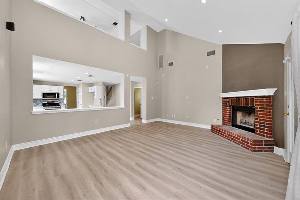 Fireplace, Interior, Kitchen, Recessed Lighting, Stainless Steel Appliances, Wood Texture Flooring