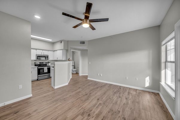 Empty room, Interior, Kitchen, Recessed Lighting, Stainless Steel Appliances, Wood Texture Flooring