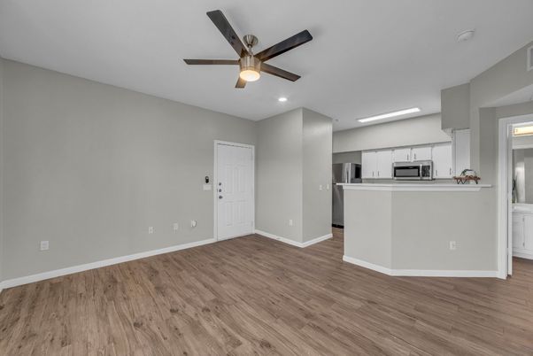 Empty room, Interior, Kitchen, Recessed Lighting, Stainless Steel Appliances, Wood Texture Flooring