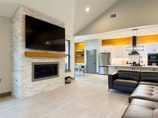 Fireplace, Interior, Kitchen, Living room, Pendant Lights, Recessed Lighting, Stainless Steel Appliances, Stone Walls, Wood Texture Flooring