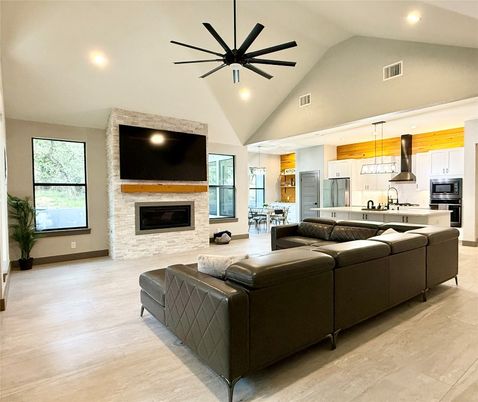 Fireplace, Interior, Kitchen, Living room, Pendant Lights, Recessed Lighting, Stainless Steel Appliances, Stone Walls, Wood Texture Flooring