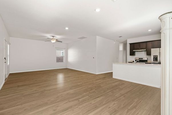 Empty room, Interior, Kitchen, Recessed Lighting, Stainless Steel Appliances, Wood Texture Flooring