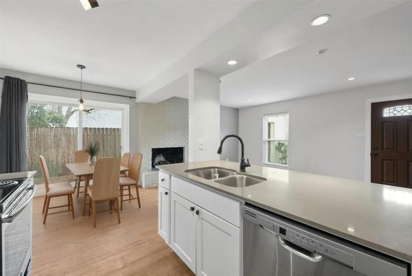 Dining room, Fireplace, Interior, Kitchen, Pendant Lights, Recessed Lighting, Stainless Steel Appliances, Stone Walls, Wood Texture Flooring