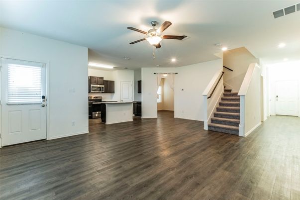 Empty room, Interior, Kitchen, Recessed Lighting, Stainless Steel Appliances, Wood Texture Flooring