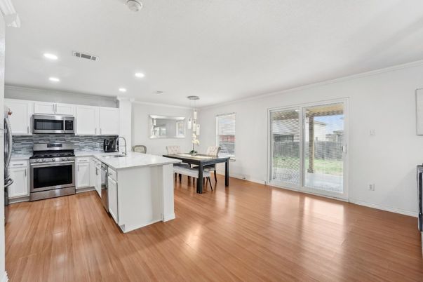Dining room, Interior, Kitchen, Pendant Lights, Recessed Lighting, Stainless Steel Appliances, Wood Texture Flooring