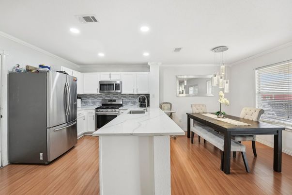 Dining room, Interior, Kitchen, Pendant Lights, Recessed Lighting, Stainless Steel Appliances, Wood Texture Flooring