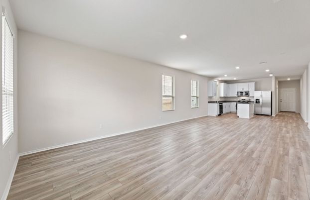 Empty room, Interior, Kitchen, Recessed Lighting, Stainless Steel Appliances, Wood Texture Flooring
